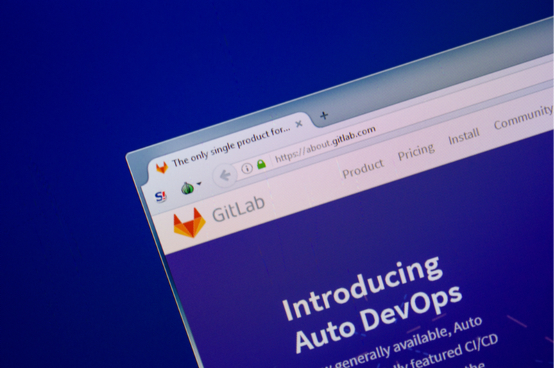 The GitLab homepage appears on the PC display