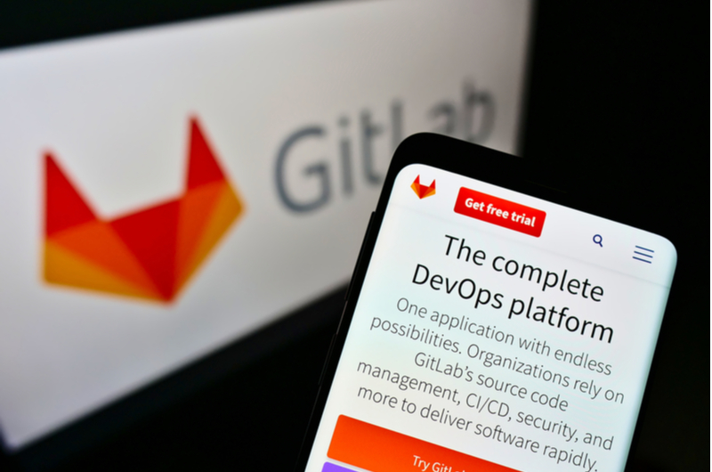 A mobile phone displaying the corporate site of the DevOps platform GitLab